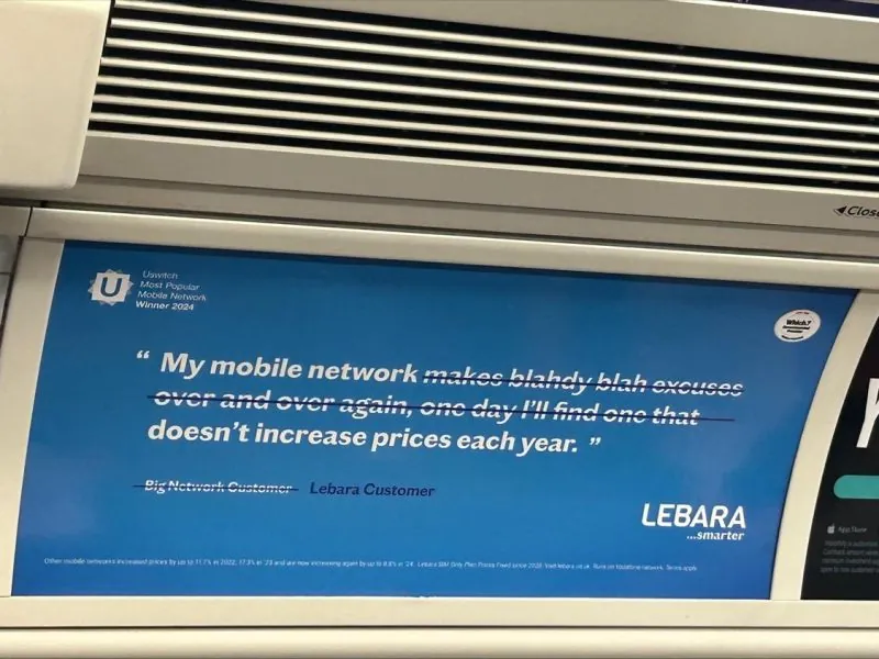 Tube card advertising above the windows of an Underground carriage