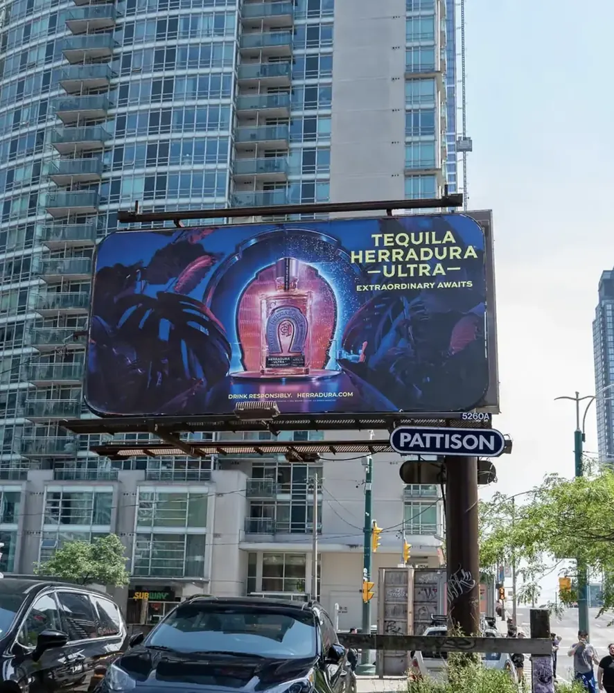 Pattison roadside billboard beside a downtown condominium tower