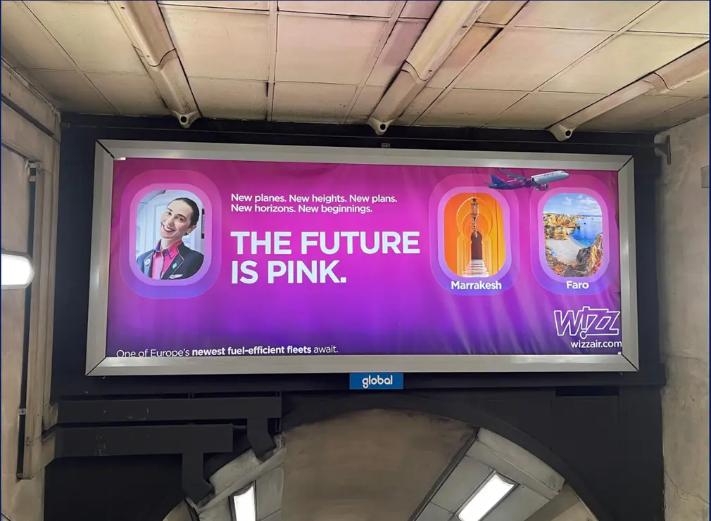Digital gateway banner screen above a London Underground walkway