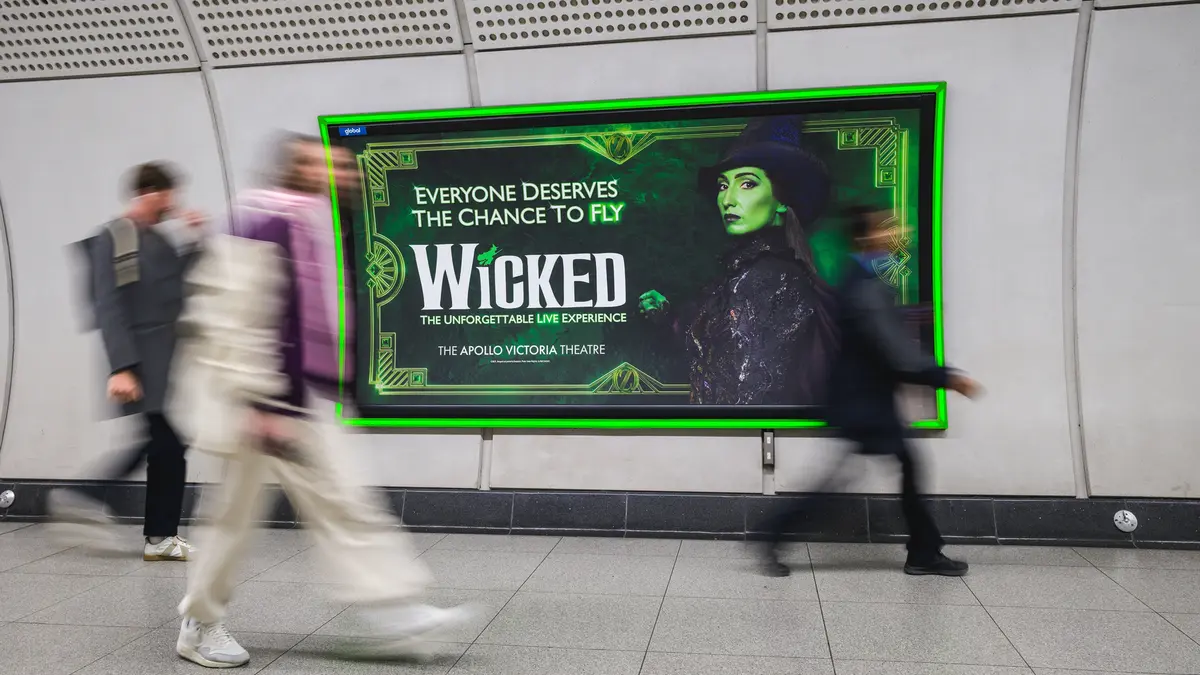 Large digital advertising screen on a London Underground platform