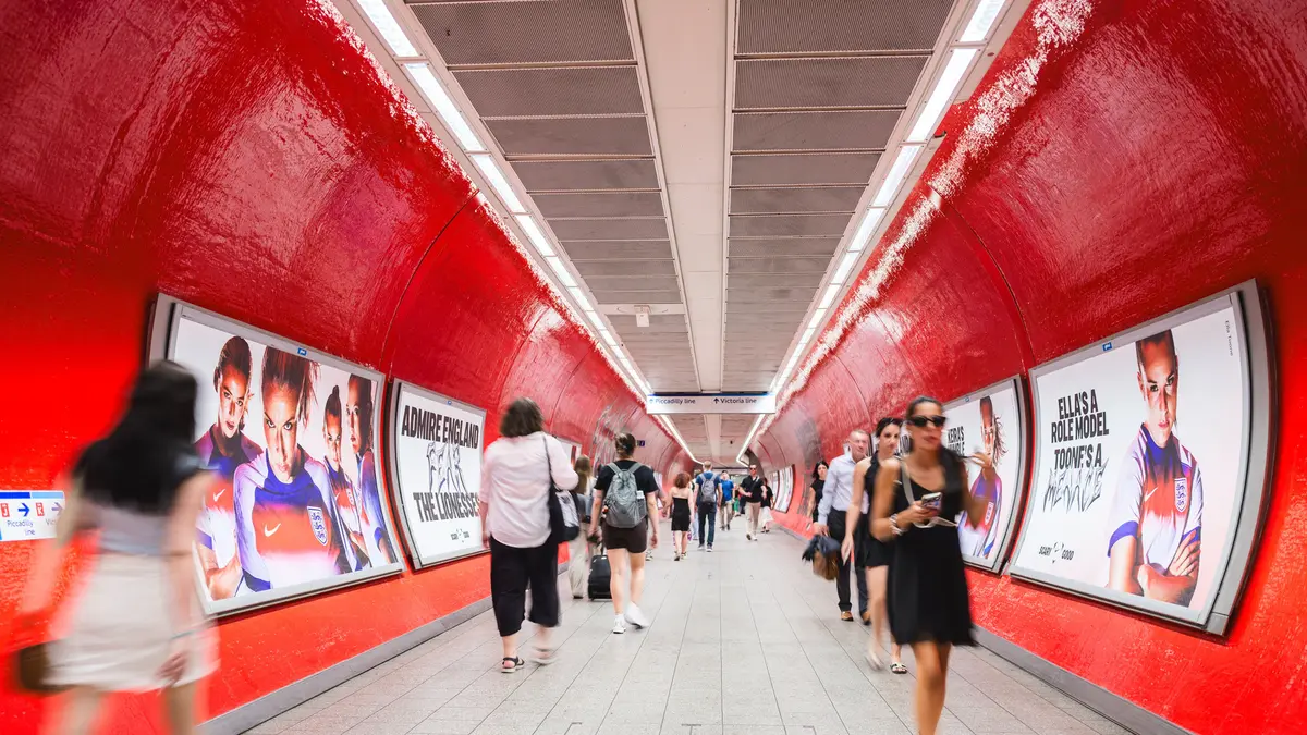 London Underground station corridor wrapped floor to ceiling in one brand's advertising